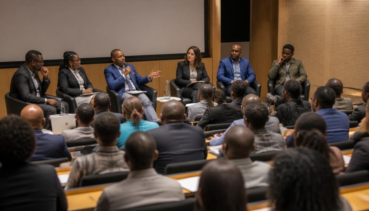 A public panel discussing AI ethics with a university audience